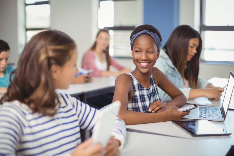 Students interacting with each other in classroom